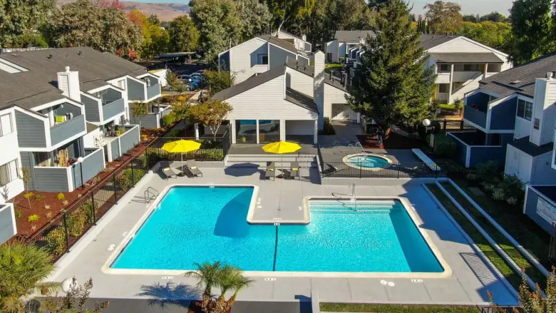 Aerial view of a renovated IEC apartment community with a pool